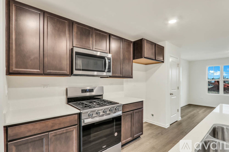 A kitchen with brown cabinets and a stainless steel oven.