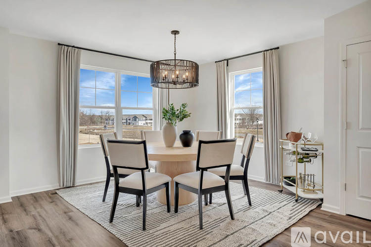 A dining room with a table set for four and a view of the city.