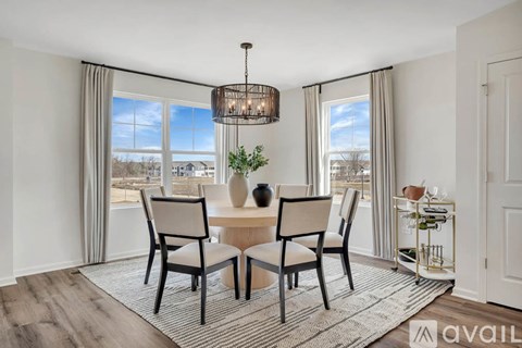 A dining room with a table set for four and a view of the city.
