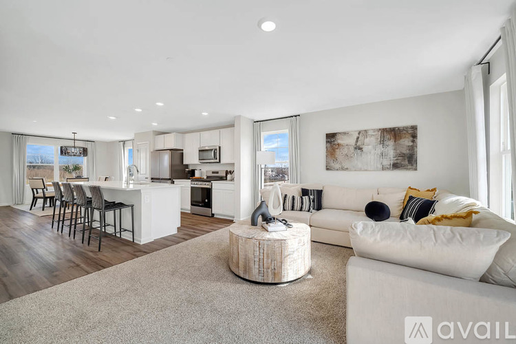 A modern living room with a white couch and a wooden coffee table.