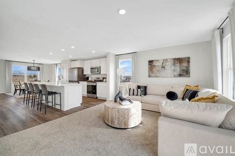 A modern living room with a white couch and a wooden coffee table.