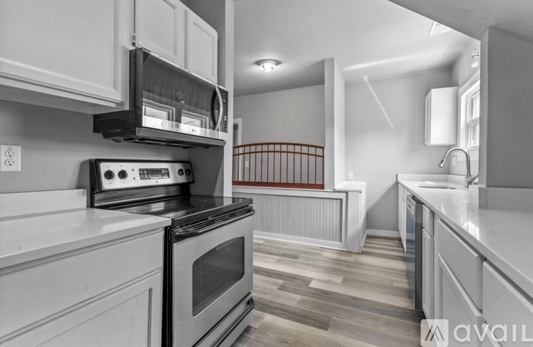 A modern kitchen with a stove, oven, and cabinets.