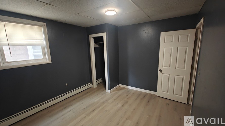 A room with a door, a window, and a wall.