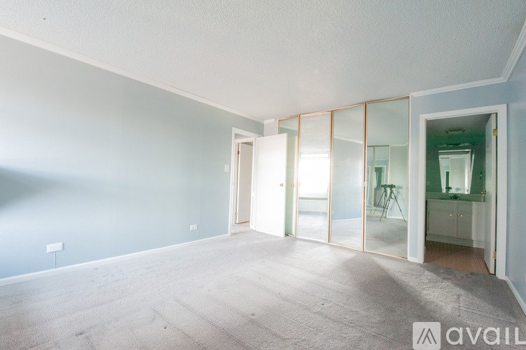 A room with a white ceiling and a glass door leading to another room.