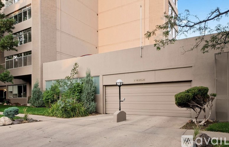 A modern building with a garage door and a lamp post in front.