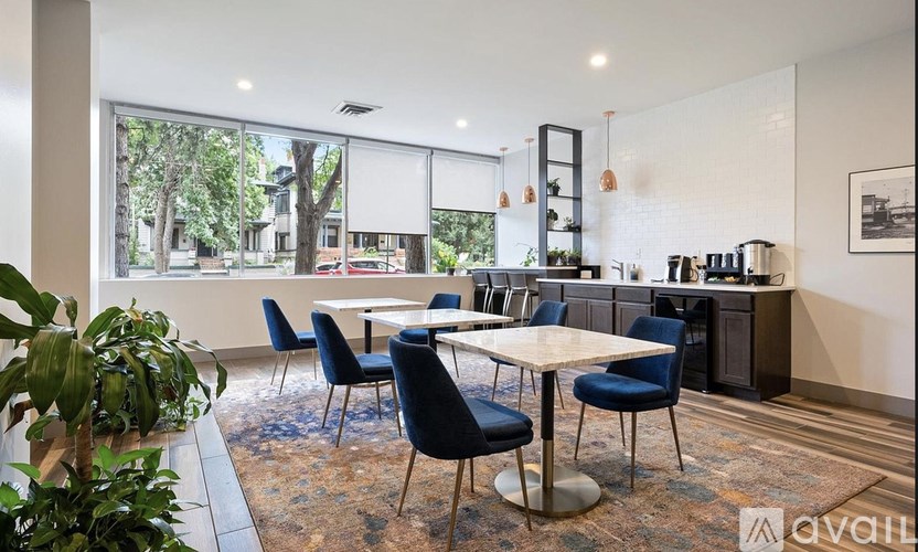 A modern dining room with a large table and chairs.