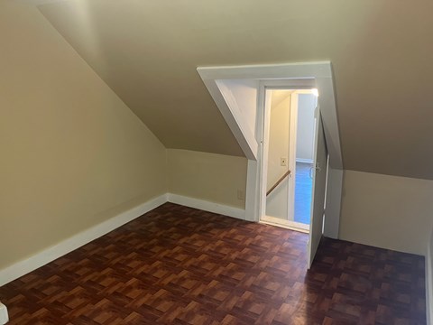 A room with a wooden floor and a white door.