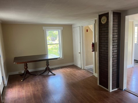 A room with a table and a window.