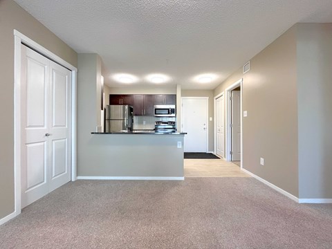 A kitchen area with a refrigerator, oven, and microwave.