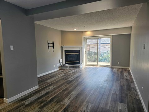 A living room with a fireplace and sliding glass doors.