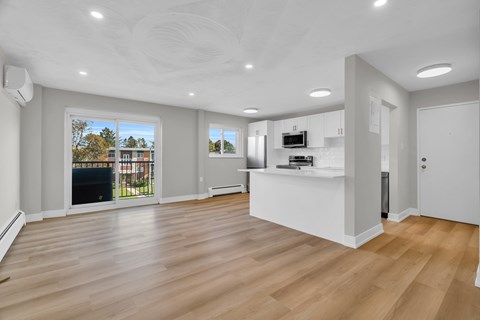 A spacious living room with a fireplace and a television.