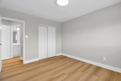 A room with a wooden floor and white walls.