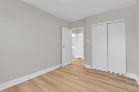 A room with a white door and a white wardrobe.