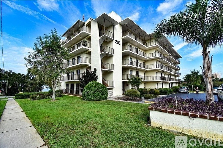 A white apartment building with the number 208 on the side.