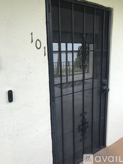 A black door with a window and a handle.