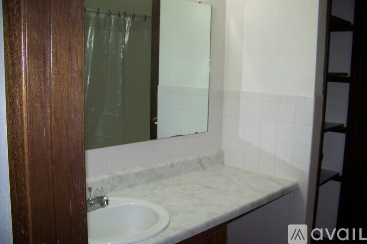 A bathroom with a sink and mirror.