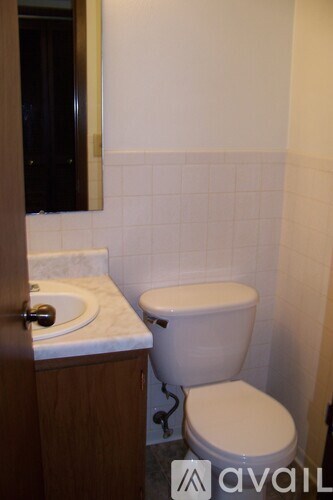 A white toilet sits next to a sink in a bathroom.