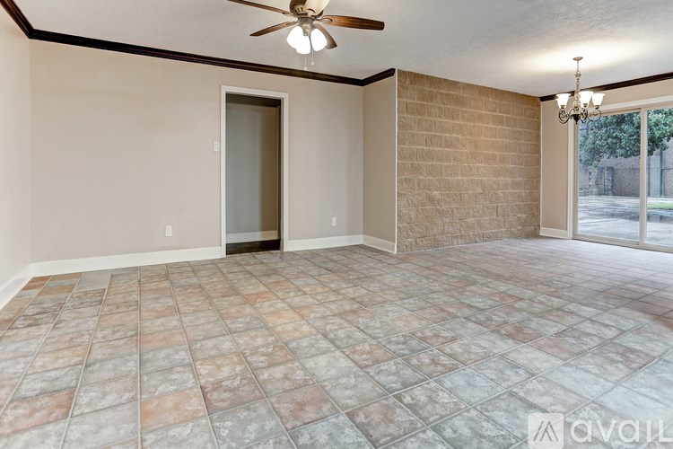A room with a ceiling fan and tiled flooring.