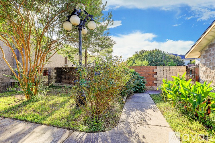 A street lamp stands in the middle of a garden.