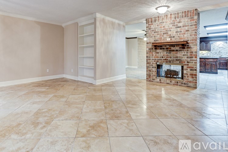 A living room with a fireplace and a tiled floor.