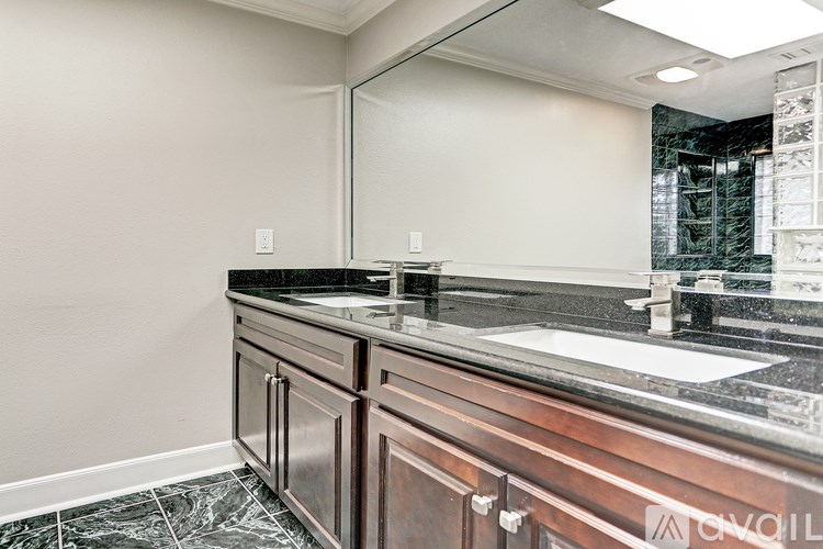 A bathroom with a sink and a mirror.