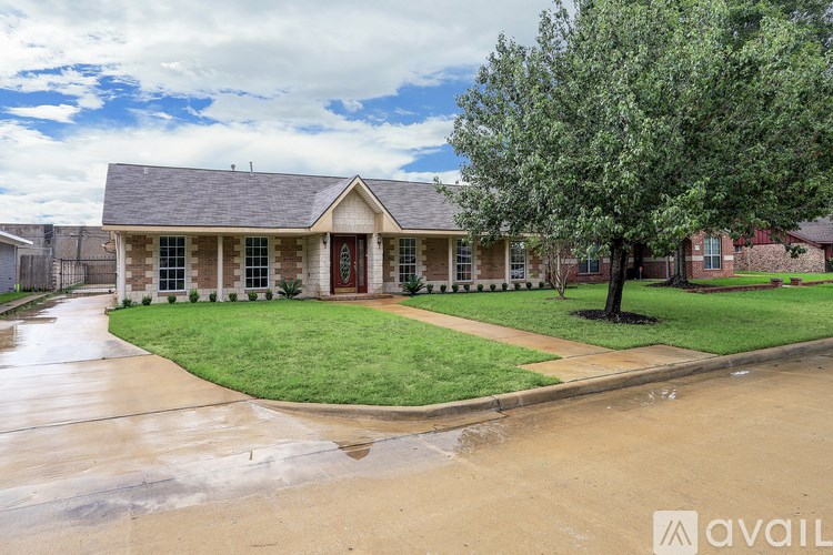A house with a red door and a tree in front.