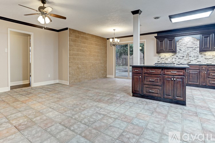 A kitchen with a tile floor and a ceiling fan.