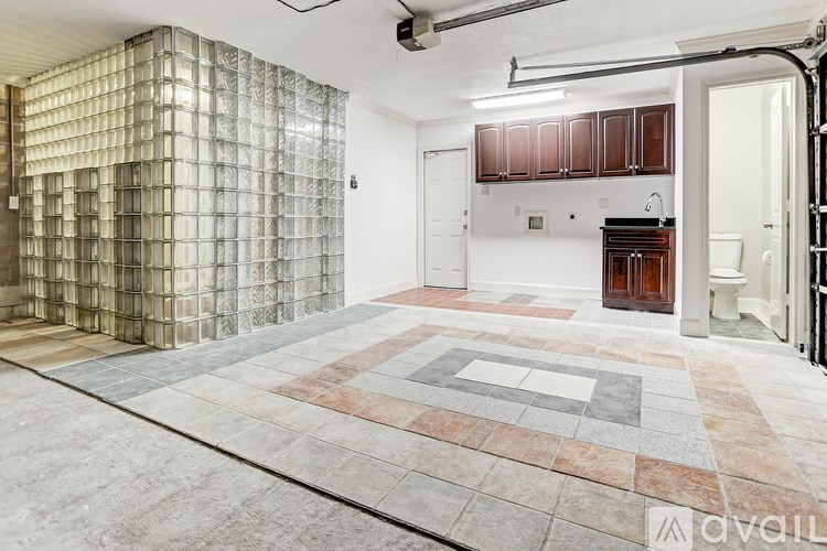 A room with a tiled floor and a wall of glass blocks.