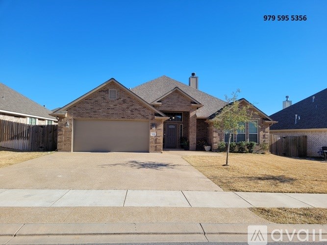 A house with a garage and a driveway is for sale.