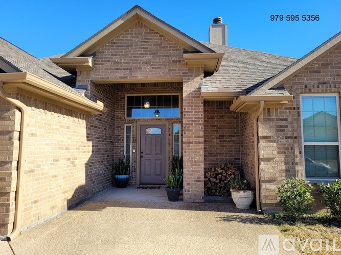 A house with a grey door and a brick wall.