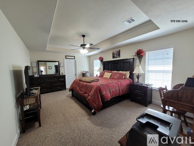A bedroom with a bed, dresser, and mirror.