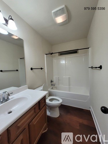 A white sink and toilet in a small bathroom.