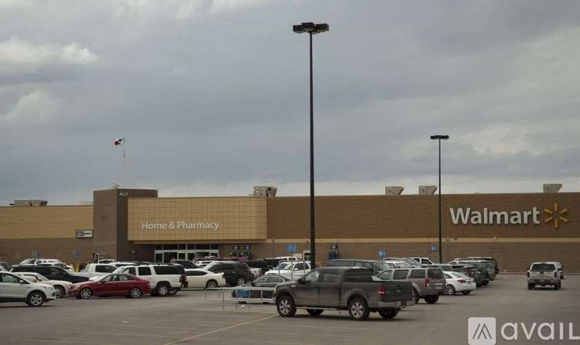 A Walmart store with a parking lot in front.