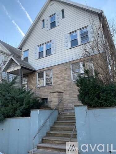 A house with a staircase leading to the front door.