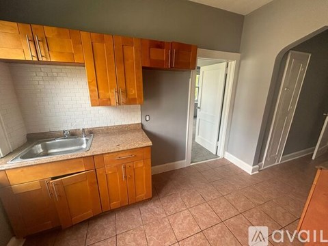A kitchen with wooden cabinets and a sink.