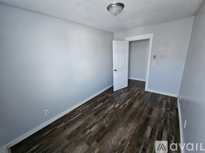 A room with wooden floors and a white door.