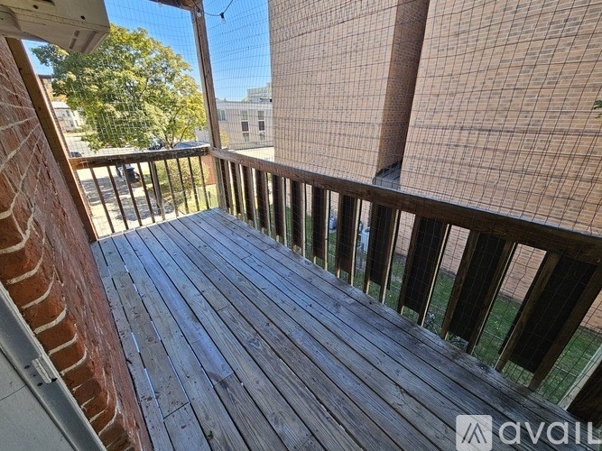 A wooden deck with a mesh screen on the right side.