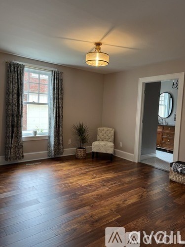 A room with wooden floors and a chair.