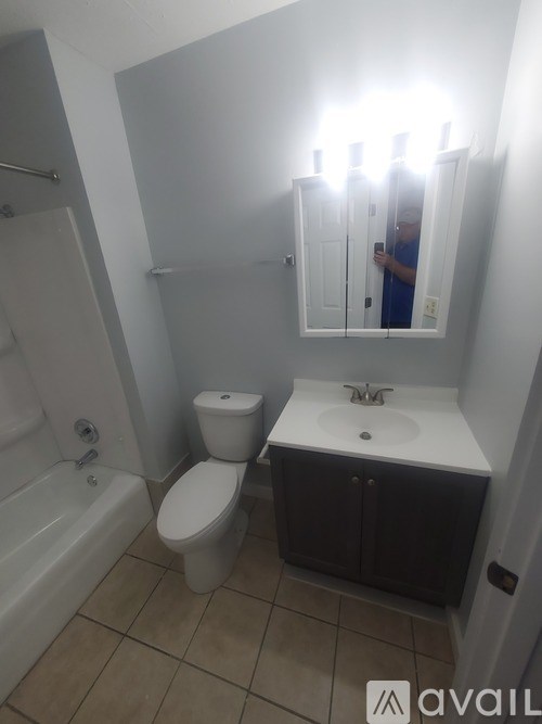 A bathroom with a toilet, sink, and bathtub.