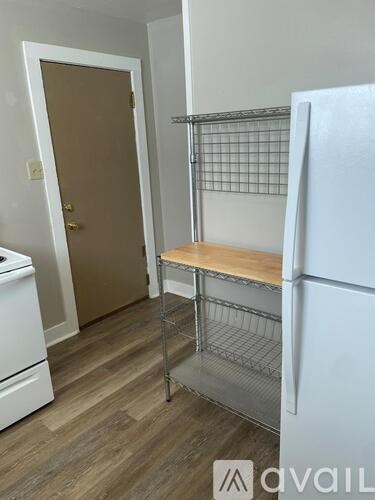 A kitchen with a white fridge and a white dishwasher.