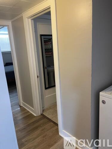 A white door with a glass window is open.