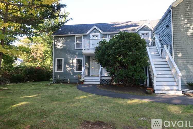A house with a front yard and a tree.