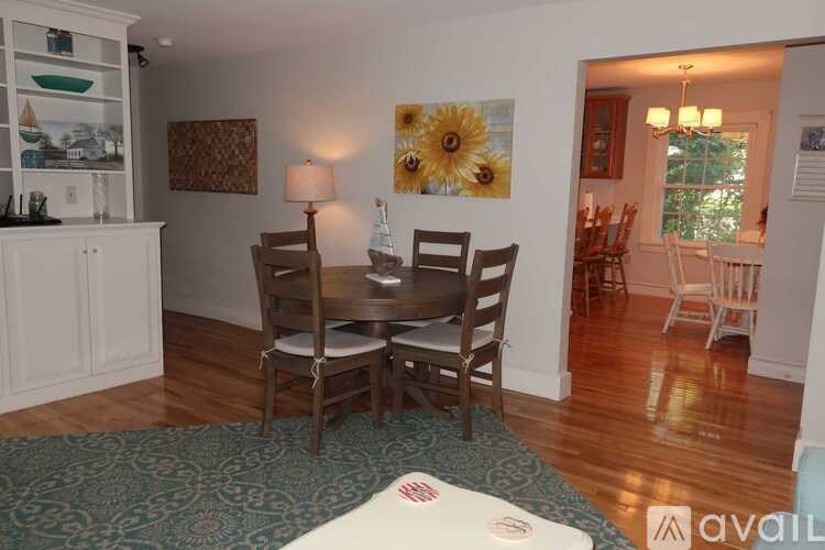 A dining room with a table set for four.