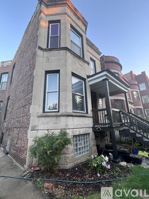 A building with a balcony and a window with a view of the sky.