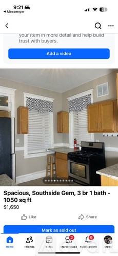 A kitchen with wooden cabinets and a black stove top oven.