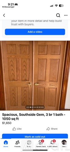 A wooden door with a glass panel in the middle.