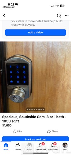 A digital keypad is mounted on a wooden door.