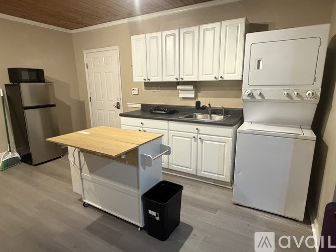 A white door with a grey curtain is open.