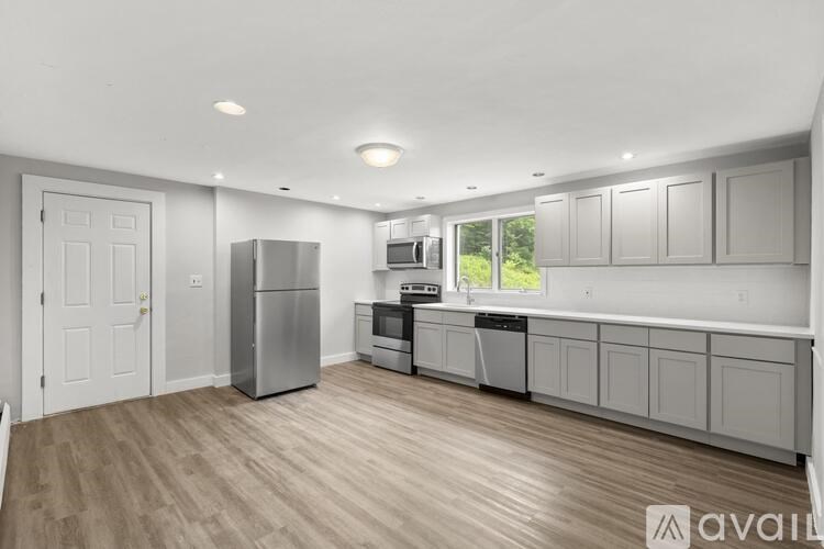 A kitchen with wooden floors and white walls.