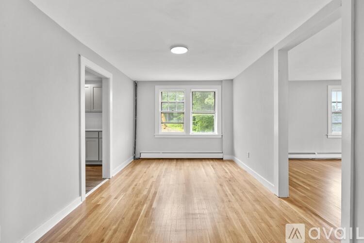 A room with wooden floors and white walls.